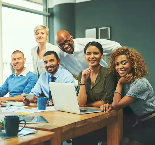 Team Care Compliance consultants sat at the desk for a group photo